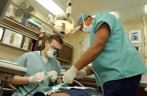 US_Navy_030124-N-1328C-510_Navy_dentist_treats_patients_aboard_ship