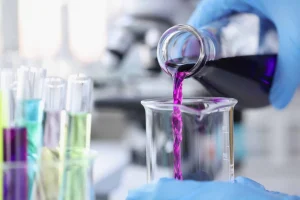 scientist-pouring-pink-chemicals